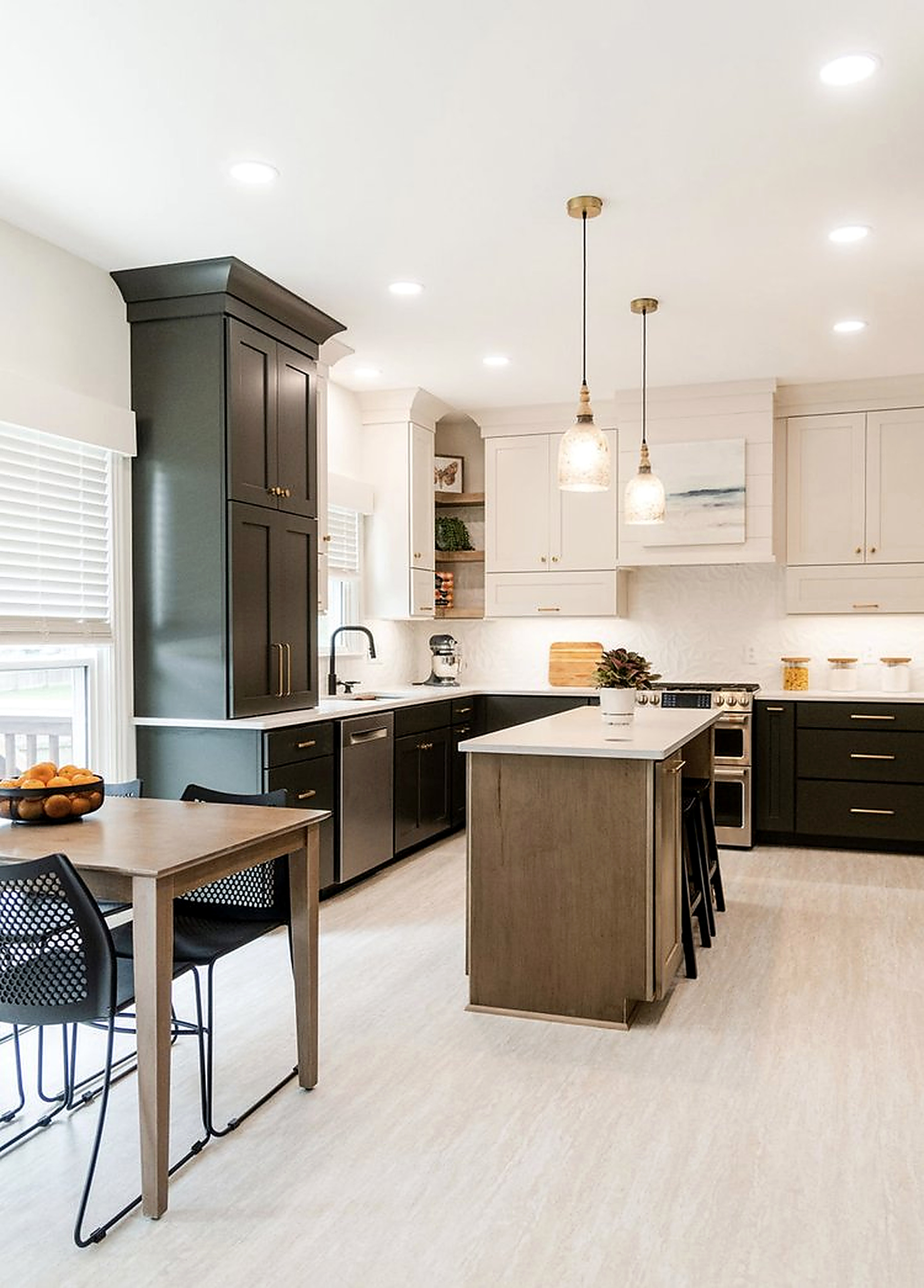 Sage gray kitchen cabinetry with quartz counters