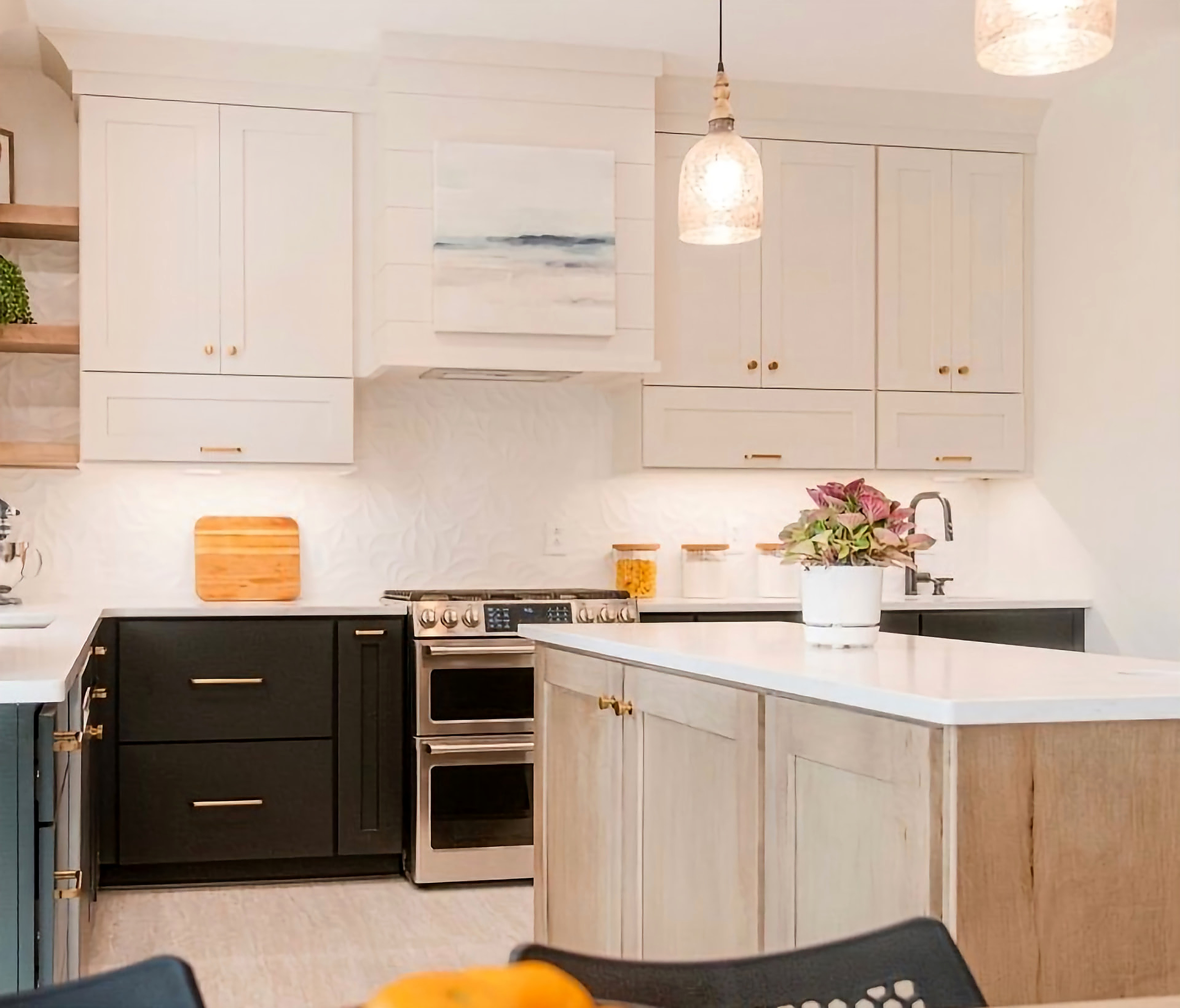Cream cabinetry with wood island and double oven range